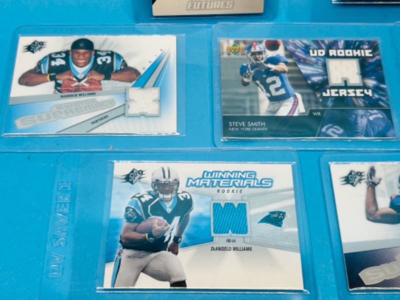 Photo 2 of 811613…7 football jersey relic Rookie cards in hard plastic sleeves 