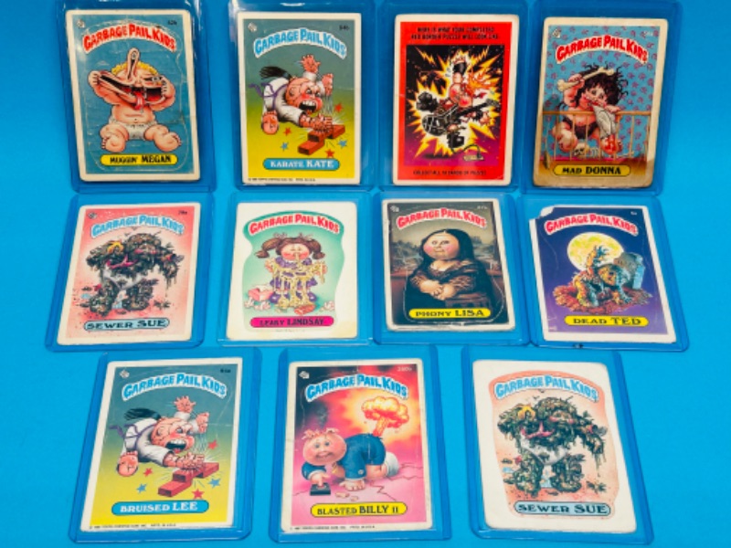 Photo 1 of 811745…11 damaged vintage garbage pail kids sticker cards in hard plastic sleeves- stains, bends, creases 