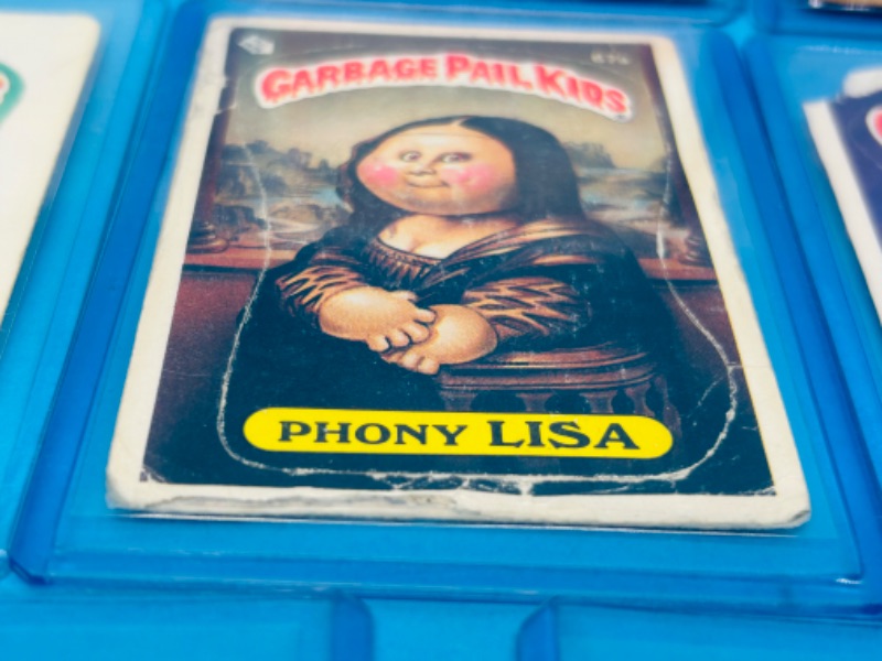 Photo 2 of 811745…11 damaged vintage garbage pail kids sticker cards in hard plastic sleeves- stains, bends, creases 