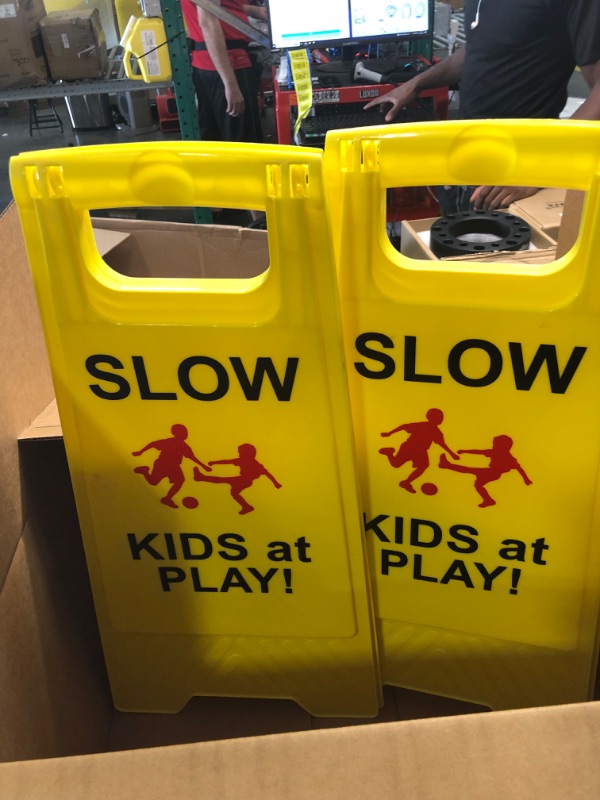 Photo 1 of Slow Kids at Play Signs, Children at Play Safety Signs 2 Pack, Text and Graphics Easier to Identify, Yellow Double Sided Signs for Schools, Street, Neighborhoods, Park, Day Cares, Sidewalk, Driveway