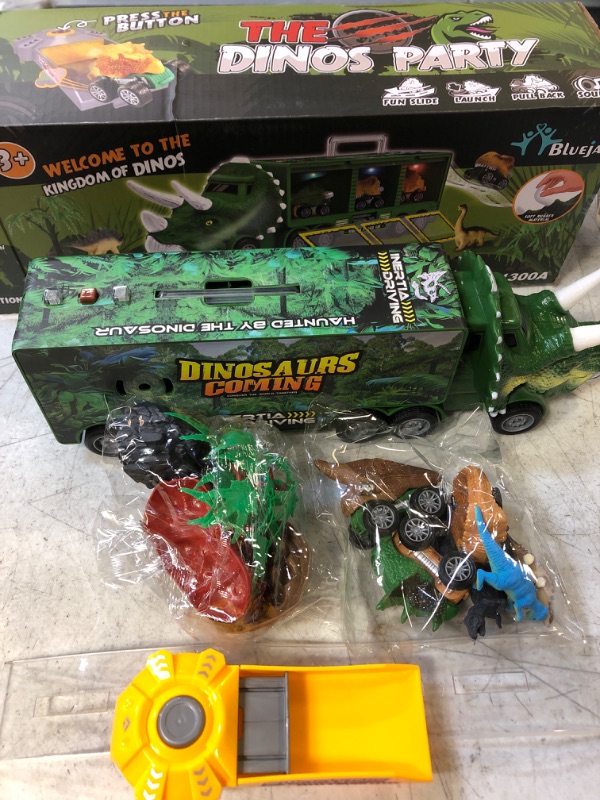 Photo 2 of BLUEJAY 21 Pack Dinosaur Toys for Kids 3-7, Dinosaur Truck with Oversized Dinosaur Map, Flashing Lights, Music and Roaring Sound, Kids Toys with 6 Pull Back Dinosaur Cars, 6 Dinosaur Toys (Green)