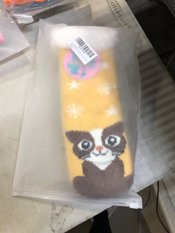 Photo 1 of girls yellow fluffy cat socks