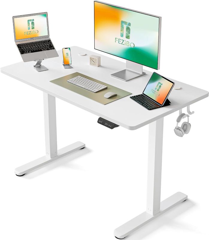 Photo 1 of FEZIBO Height Adjustable Electric Standing Desk, 48 x 24 Inches Stand Up Table, Sit Stand Home Office Desk with Splice Board, White Frame/White Top