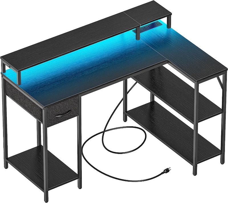 Photo 1 of SUPERJARE L Shaped Gaming Desk with LED Lights & Power Outlets, Reversible Computer Desk with Shelves & Drawer, Corner Desk Home Office Desk, Black