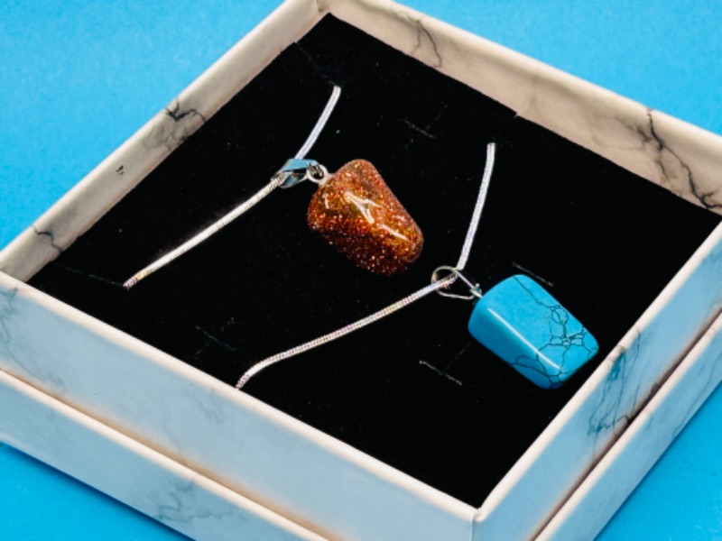 Photo 1 of 150214…  2 polished rock pendants on chains in gift box