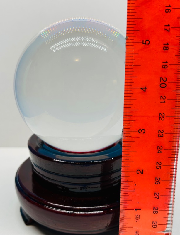 Photo 3 of 150412…clear 4” glass ball on wood stand 