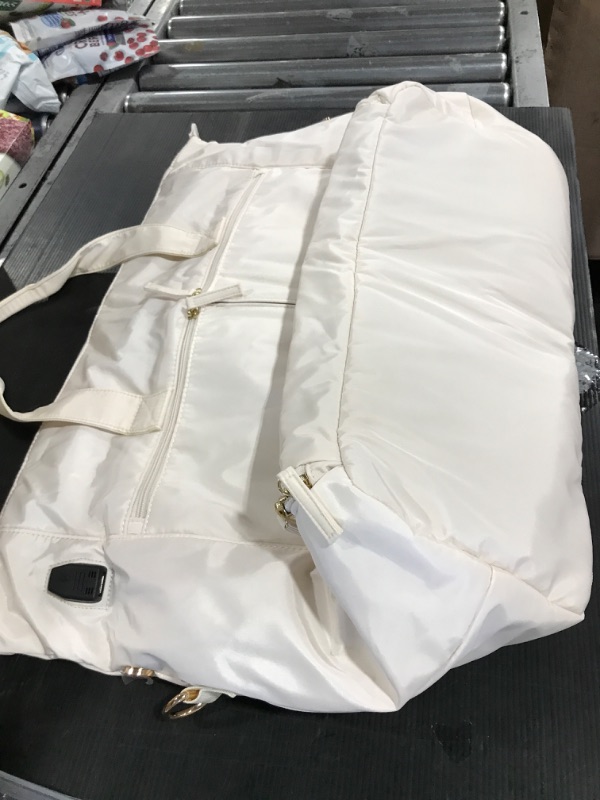 Photo 1 of Cream white Carrying Bag with smaller bag and also charging port for portable charger.