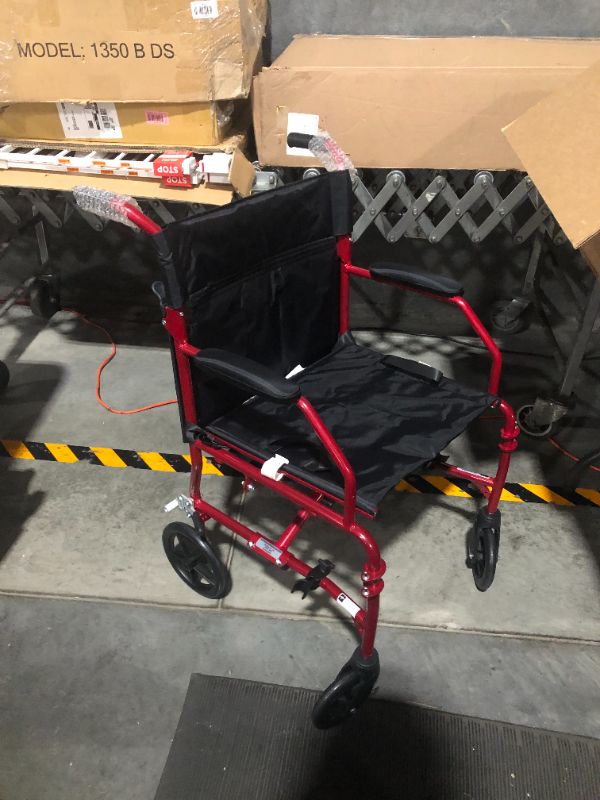 Photo 2 of ***ONE OF THE FOOT RESTS IS MISSING***
Medline Ultralight Transport Wheelchair with 19” Wide Seat, Folding, Red Frame