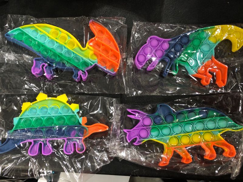 Photo 1 of 4PK OF POP IT FIDGET DINOSAUR TOYS