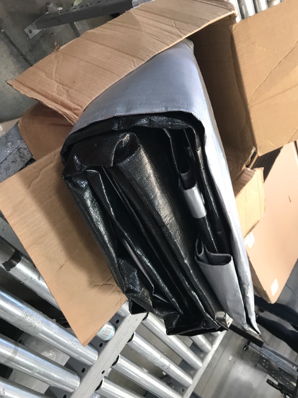 Photo 1 of TORN TARP**Core Tarps Heavy Duty 10 Mil Tarp Cover, Waterproof, UV Resistant, Rip and Tear Proof, Poly Tarpaulin with Reinforced Edges for Roof, Camping, Patio, Pool , Boat (Silver/Black 10? X 20?) Silver/Black-10 Mil 10? X 20?