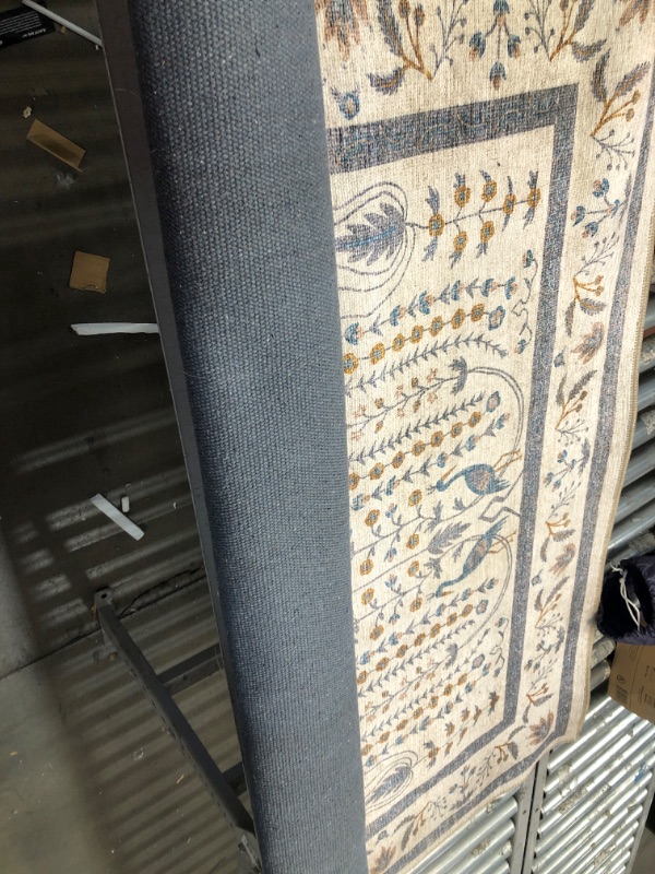 Photo 1 of **USED** Large Tan Rug with designs, unspecified size