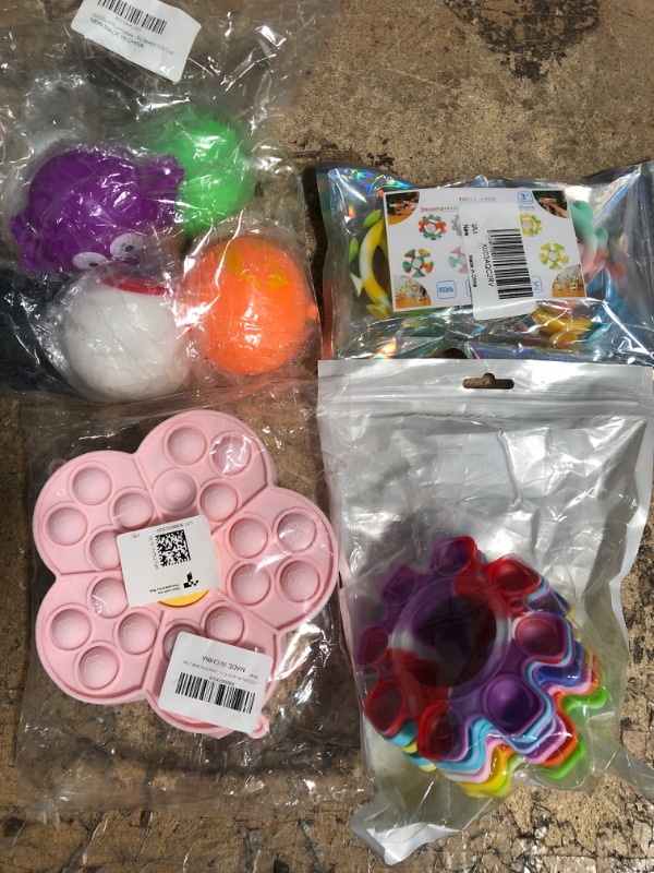 Photo 1 of 4 assorted items fidget spinner and fidget pop