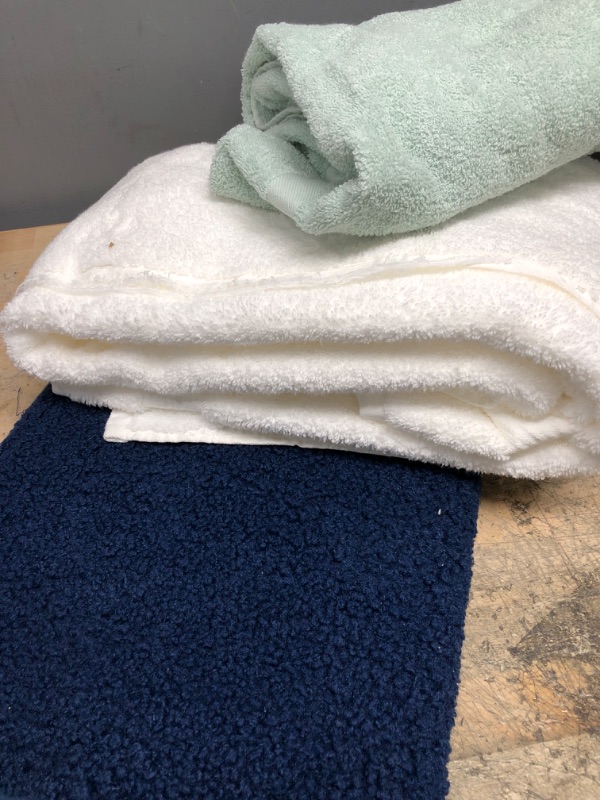 Photo 1 of **WHITE TOWEL IS TORN ON ONE EDGE**
1 BATH MAT AND 2 TOWELS