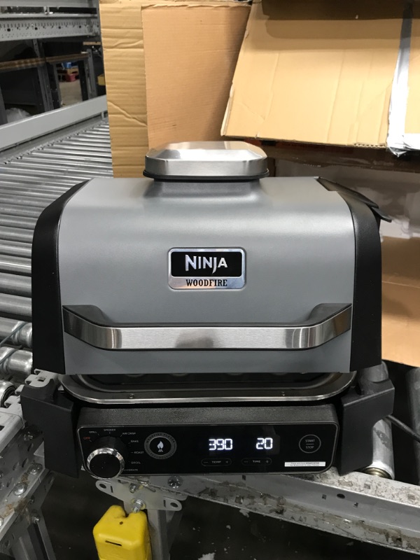 Photo 2 of ***TESTED/ TURNS ON** Ninja OG701 Woodfire Outdoor Grill & Smoker, 7-in-1 Master Grill, BBQ Smoker, & Air Fryer plus Bake, Roast, Dehydrate, & Broil, uses Ninja Woodfire Pellets, Weather-Resistant, Portable, Electric, Grey
