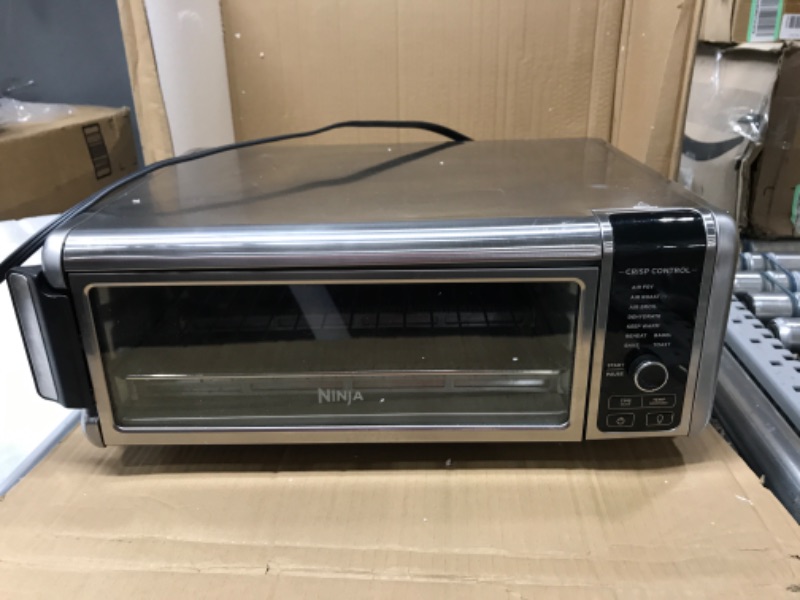 Photo 2 of (*MAJOR DAMAGE *)Ninja Foodi SP101/FT102CO Digital Fry, Convection Oven, Toaster, Air Fryer, Flip-Away for Storage, with XL Capacity, and a Stainless Steel Finish