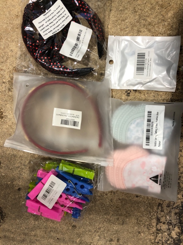 Photo 1 of 10 assorted items, teething helper, headband, fidget toy, dream bella, clothe plastic clip holders, and misc