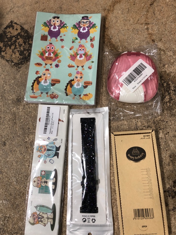 Photo 1 of 10 assorted items thanksgiving stickers, kid tattoos, number 3 candle, apple watch wristband, key chain holder, fidget toys, and misc