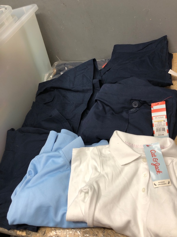 Photo 1 of BUNDLE OF 7 ASSORTED KIDS UNIFORMS- (5 navy blue skirts XXl 18 plus for kids , 1white shirt 5t, 1blue shirt medium)