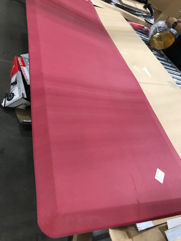 Photo 2 of torn material**Anti Fatigue Kitchen Floor Mat, Standing Desk Mat, Cushioned Comfort Mat for Home, Office, Laundry,Pain Relief, Non Slip Bottom, Waterproof & Easy to Clean, 24"x72", Burgundy 24" x 72"- 3/4" Burgundy