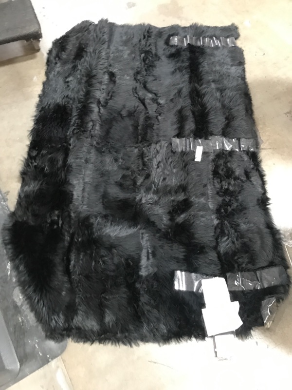 Photo 1 of 6ft x 4ft black fur rug.