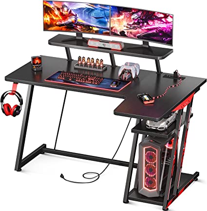 Photo 1 of MOTPK Gaming Desk L Shaped, Small Corner Desk with Storage Shelf & Power Outlets, Computer Desk with Monitor Shelf, L Shaped Desk with Carbon Fiber Surface, Gamer Desk Gaming Table, Black, 47 Inch
