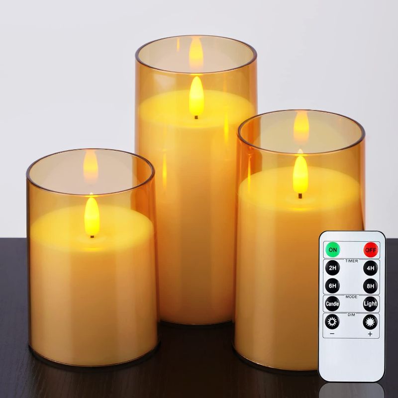 Photo 1 of Amagic Set of 3 Gold Acrylic Flickering Flameless Candles, 3D Wick, Unbreakable Battery Operated Plexiglass LED Pillar Radiance Candles with Remote Control and Timer,3" x 4"5" 6", Amber
