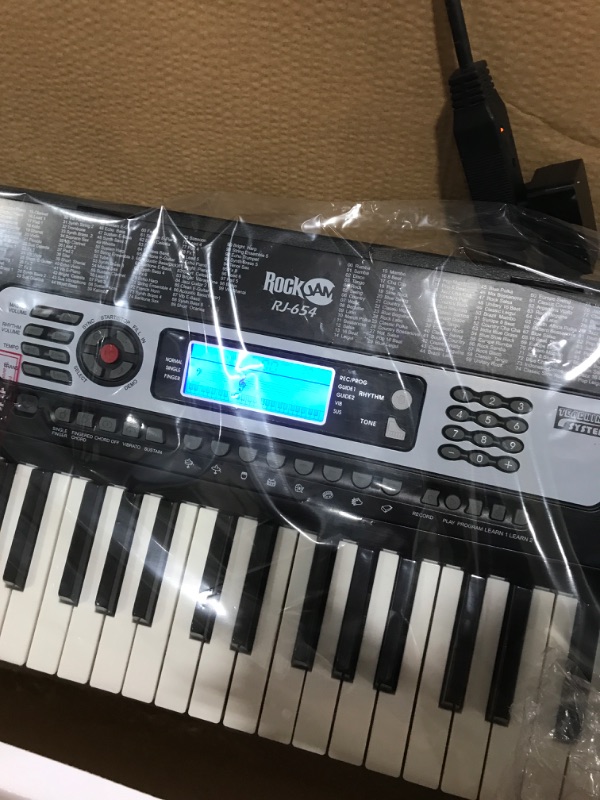 Photo 2 of RockJam 54-Key Portable Electronic Keyboard with Interactive LCD Screen & Includes Piano Maestro Teaching App with 30 Songs & Adjustable Keyboard Stand with Locking Straps & Quick Release Mechanism