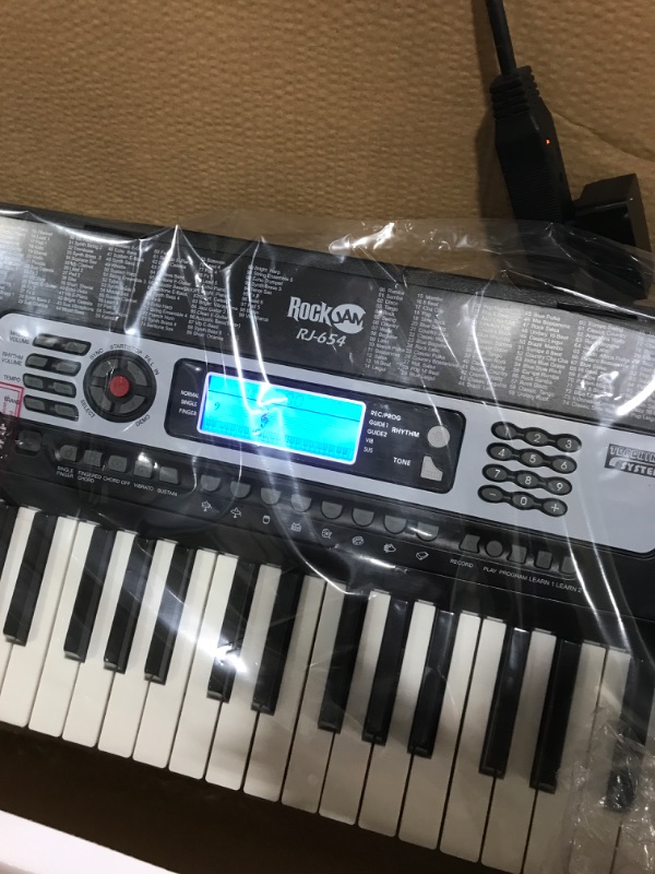 Photo 1 of RockJam 54-Key Portable Electronic Keyboard with Interactive LCD Screen & Includes Piano Maestro Teaching App with 30 Songs & Adjustable Keyboard Stand with Locking Straps & Quick Release Mechanism