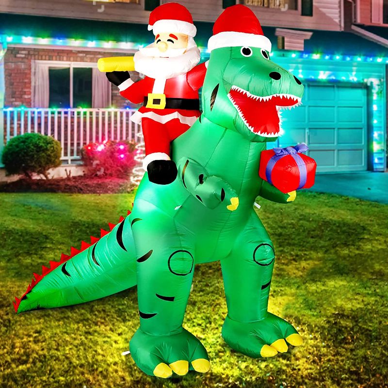 Photo 1 of Christmas Inflatable Santa Dinosaur Decorations, LEITAO 7 FT Giant Blow Up LED Light Up Inflate Xmas Santa Dinosaurs Gift Box Decor for Xmas Indoor Outdoor Yard Garden Party Holiday Decorations
