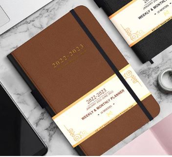 Photo 1 of Modern Mercantile Planner 2022-2023 - 5.8" x 8.3" Jan 2022 - June 2023 Monthly Planner with Weekly and Monthly Planning, Faux Leather Hard Cover, Gold Pen, Book Case, Bookmark and Elastic Band Brown