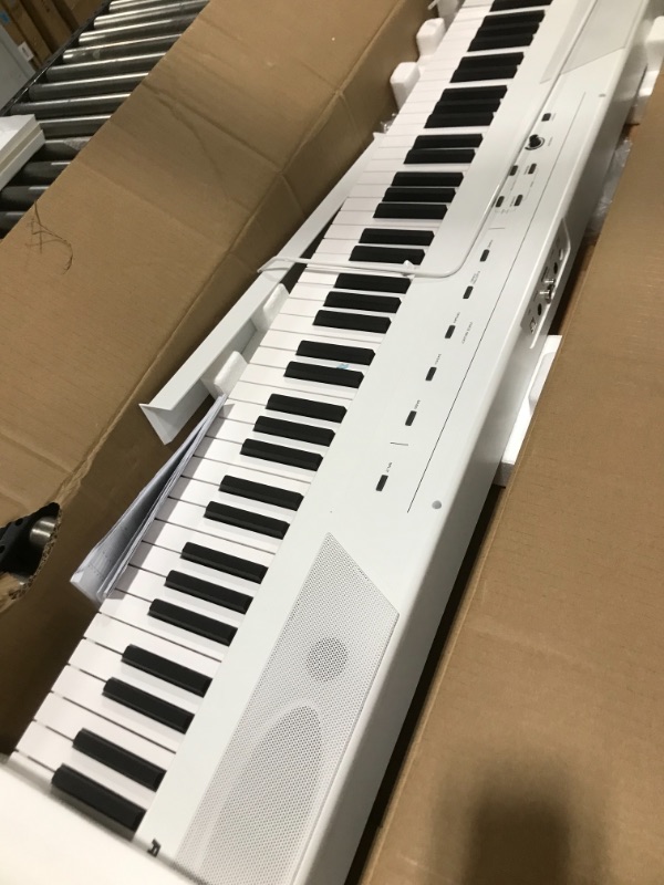 Photo 2 of Alesis Recital – 88 Key Digital Piano Keyboard with Semi Weighted Keys, 5 Voices, Piano Lessons, M-Audio Sustain Pedal and HDH40 Piano Headphones Recital White Piano + Sustain Pedal + Headphones