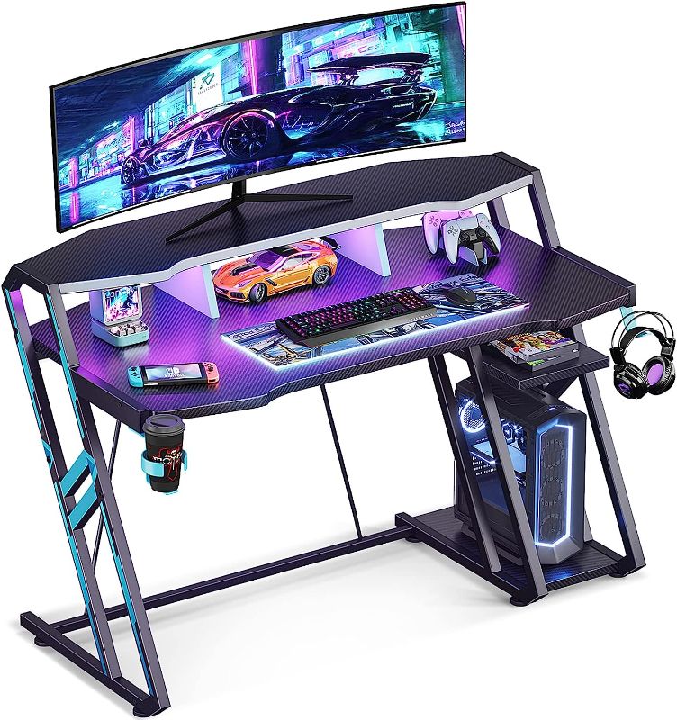 Photo 1 of MOTPK Gaming Desk with LED Lights 47 Inch, Computer Desk with Monitor Storage Shelf, Gaming Table with Carbon Fiber Surface, Gamer Desk with Cup Holder & Headphone Hook, Gift for Boys Men, Black
