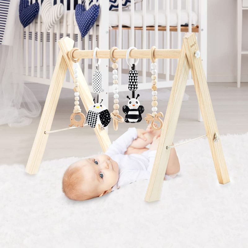 Photo 1 of BABY K Wooden Baby Play Gym (with 5 Toys) - Foldable Wooden Baby Play Gym with Wooden and Monochrome Hanging Toys - Natural Wooden Surface - Baby Tummy Time Play Gym - Activity Gym for Newborn
