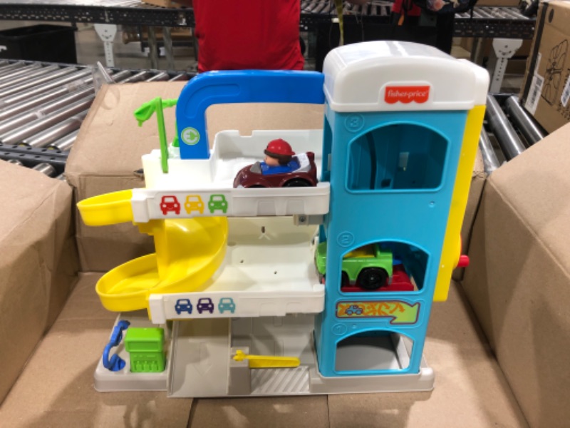 Photo 2 of Fisher-Price Little People Toddler Playset with Spiral Race Track, Elevator and 2 Wheelies Toy Cars, Helpful Neighbor’s Garage