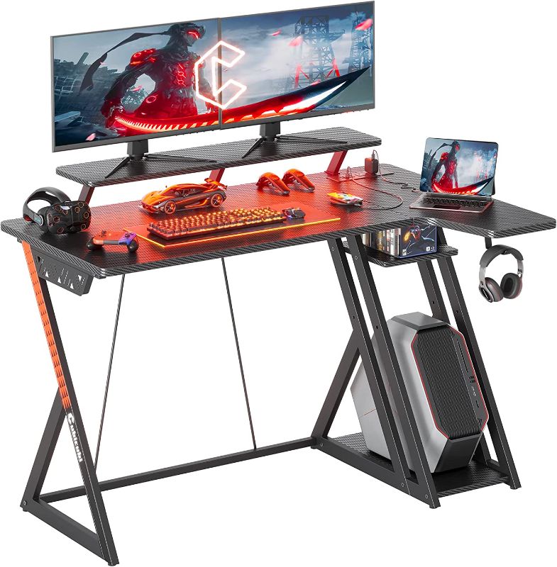 Photo 1 of CubiCubi Aurora Gaming Desk with LED Lights & Power Outlets, 40 Inch L Shaped Carbon Fiber Surface Desk with Storage Shelves, Small Corner Computer Desk with Monitor Shelf, Gamer Desk PC Table, Black