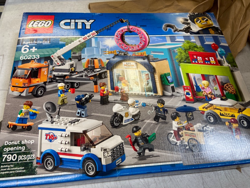 Photo 2 of LEGO City Donut Shop Opening 60233 Store Opening Build and Play with Toy Taxi, Van and Truck with Crane, Easy Build with Minifigures for Boys and Girls (790 Pieces)
