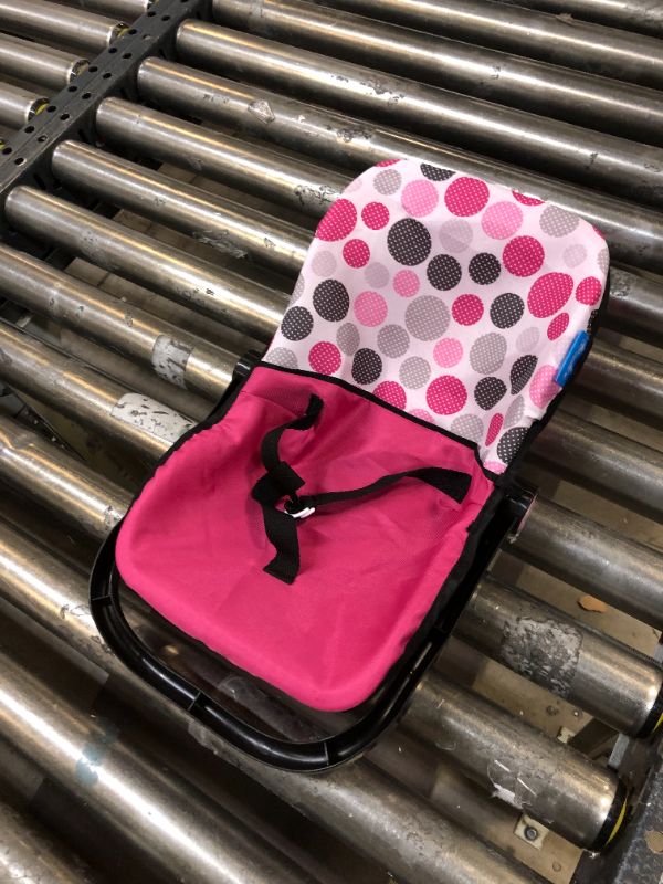 Photo 1 of Hauck Pink Dot Doll Car Seat is a Plastic Shell with Fabric and Includes Harness Belt to Keep The Baby Doll Secure and can be Converted into a Feeding Chair, Multi