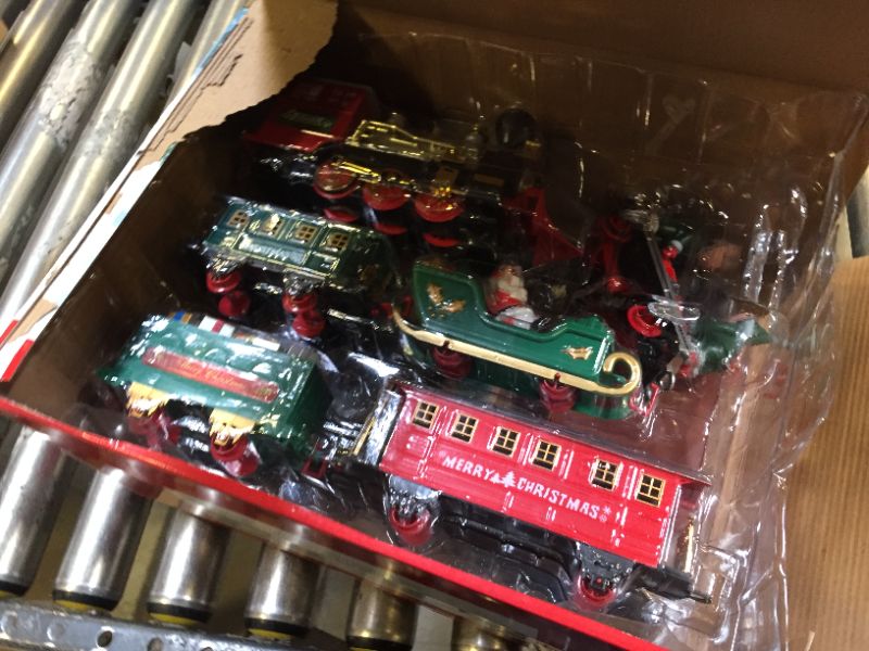 Photo 2 of JOYIN Christmas Train Set with Real Smoke, Battery Operated Electric Train Set Including Steam Locomotive Engine, Passenger Car, Gift Car, 2 Xmas Elves, 1 Santa Claus and More! Best Xmas Train Gifts