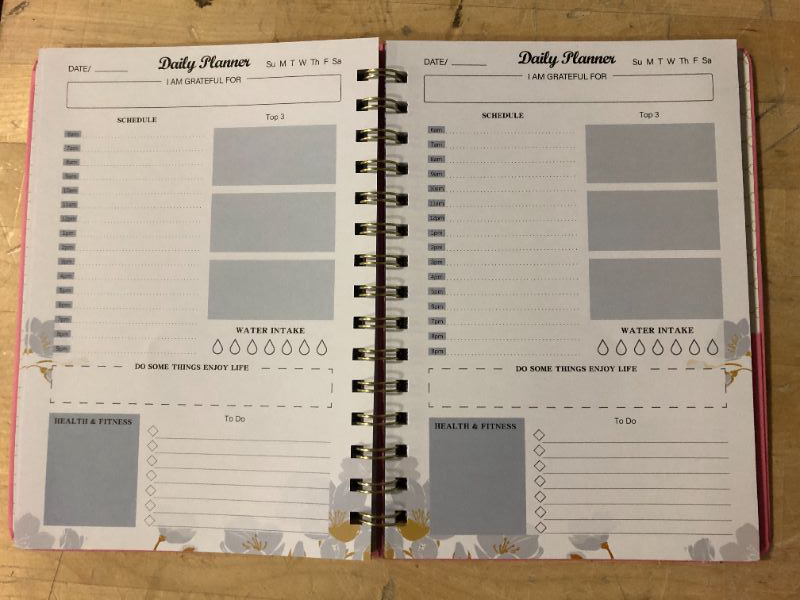 Photo 1 of Siltamu Daily Planner Undated 6.1? x 8.5?,To Do List Notebook with Hourly Schedule,Meal Planning and Spiral Appointment Organizers for Men and Women with Pocket and Pen Loop - Pink A5-Daily Planner Pink