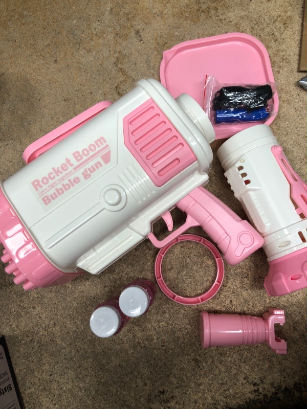 Photo 2 of Bubble Machine Gun - 2022 Upgrade 64-Hole Bubble Big Bazooka Gun Rocket Boom Bubble Machine Rocket Launcher Bubble Maker Blower for Kids Girls Adults Party (2nd Generation) - Pink