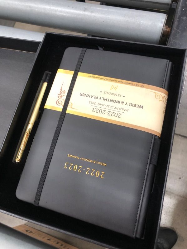 Photo 1 of Modern Mercantile Planner 2022-2023 - 5.8" x 8.3" Jan 2022 - June 2023 Monthly Planner with Weekly and Monthly Planning, Faux Leather Hard Cover, Gold Pen, Book Case, Bookmark and Elastic Band Black