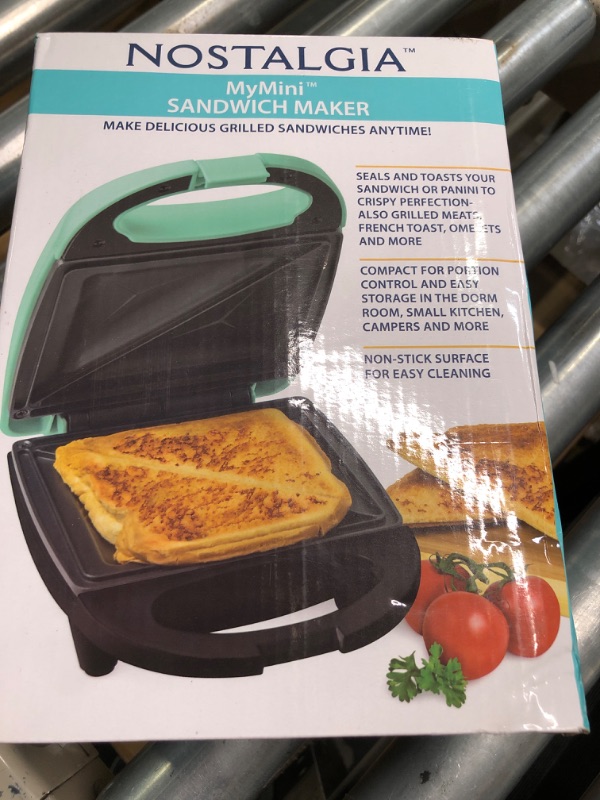 Photo 1 of 
Nostalgia mini sandwich maker toaster compact for portion control seals and toasts sandwich panini maker (RED)
