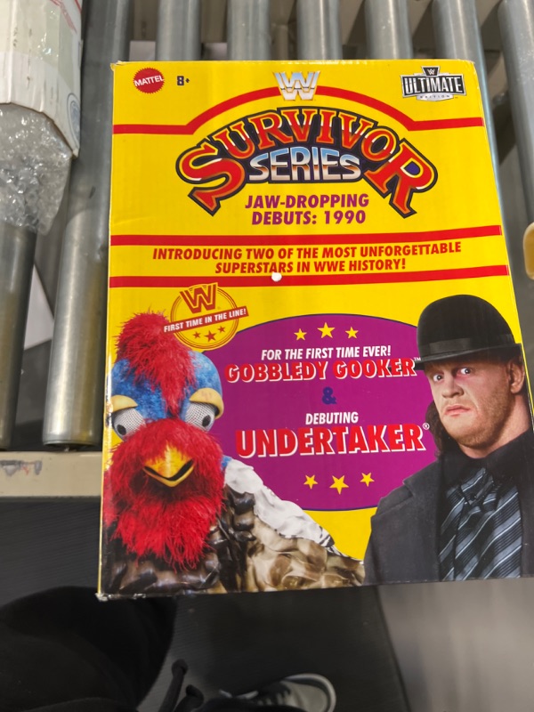 Photo 1 of Mattel WWE Action Figure 2-Pack Ultimate Edition Survivor Series 1990 Undertaker & Gobbledy Gooker Collectibles with Interchangeable Accessories, Extra Heads & Swappable Hands (Amazon Exclusive)