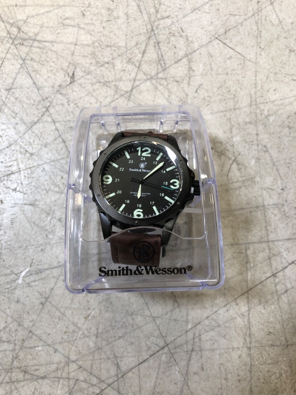 Photo 2 of Smith & Wesson Men's Classic Analog Watch
 (new, needs battery, protective peel on)
