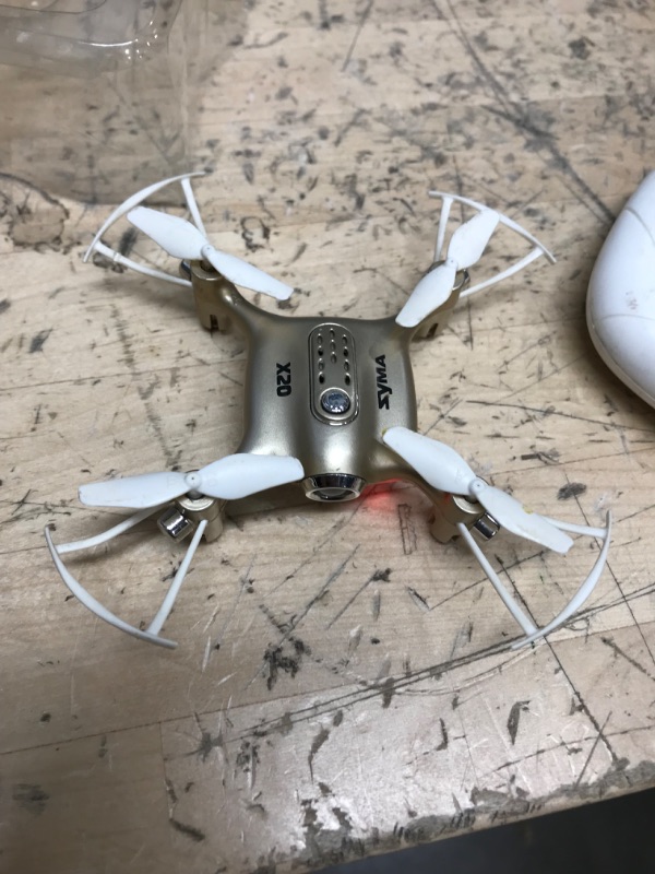 Photo 3 of **POWERS ON , MISSING CHARGING CORD**
DoDoeleph Newest Syma X20 Mini Pocket Drone Headless Mode 2.4Ghz Nano LED RC Quadcopter Altitude Hold Gold