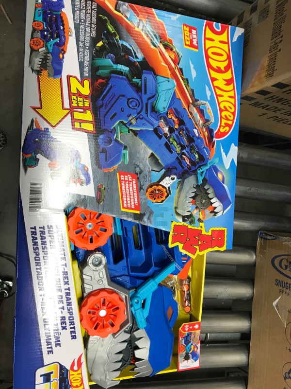 Photo 2 of Hot Wheels City Ultimate Hauler, Transforms into Stomping T-Rex with Race Track, Lights and Sounds, Toy Storage for 20+ 1:64 Scale Cars