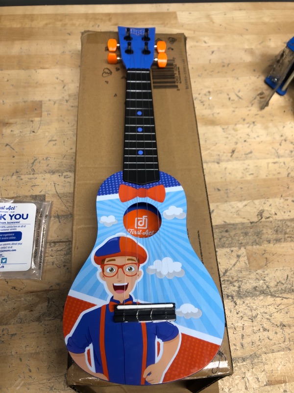 Photo 2 of Blippi Ukulele by First Act, Featuring YouTube Educational Entertainer Ukulele for Beginners, Musical Instruments & Costume Roleplay Accessories, Perfect for Dress Up and Play Time Ukulele + Accessories