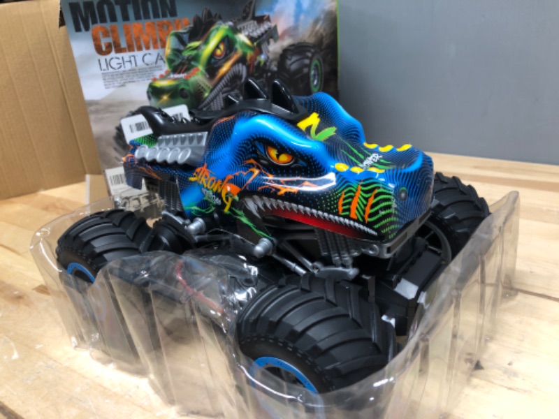 Photo 2 of Rhybor Remote Control Car 1:16 Scale RC Car Dinosaur Monster Truck Toy Vehicle with Spray Mist Music LED Lights, 2.4 GHz 20 Km/h High Speed Truck,Electric Toy Cars Best Gift for Age 4 5 6 7 8 9 Kids