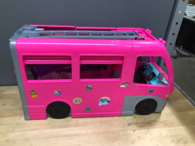 Photo 2 of Barbie Camper, DreamCamper Toy Playset with 60+ Barbie Accessories and Furniture Pieces, 7 Play Areas Including Pool and Slide