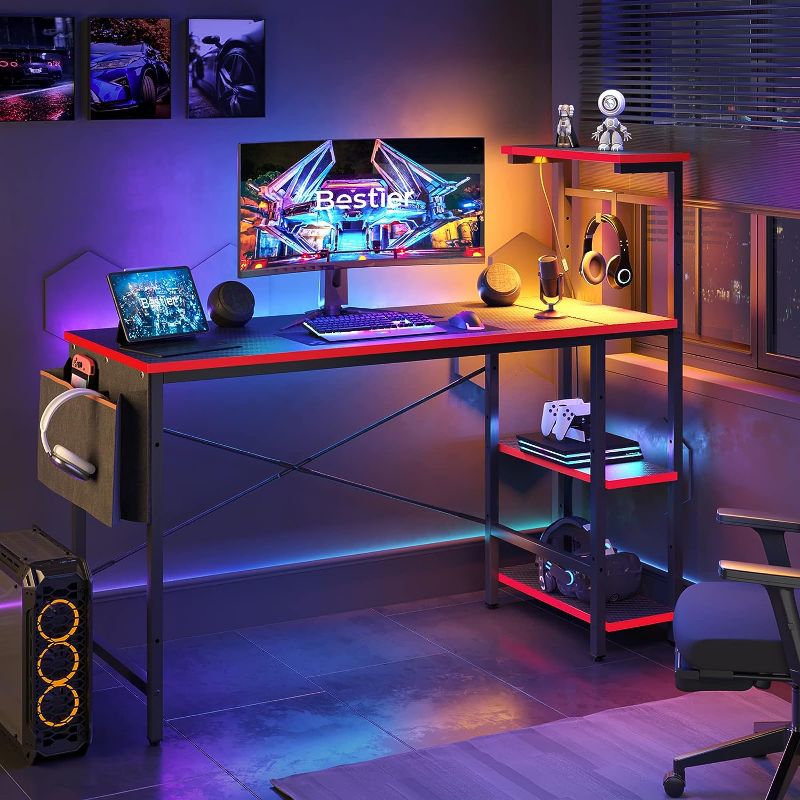 Photo 1 of **SEE NOTES**
Bestier Gaming Desk with LED Lights, Computer Desk with 4 Tiers Reversible Shelves, 51.3 Inch Gamer Desk with Side Storage Bag, Hooks and Height Adjustable Shelf (Black Carbon Fiber)